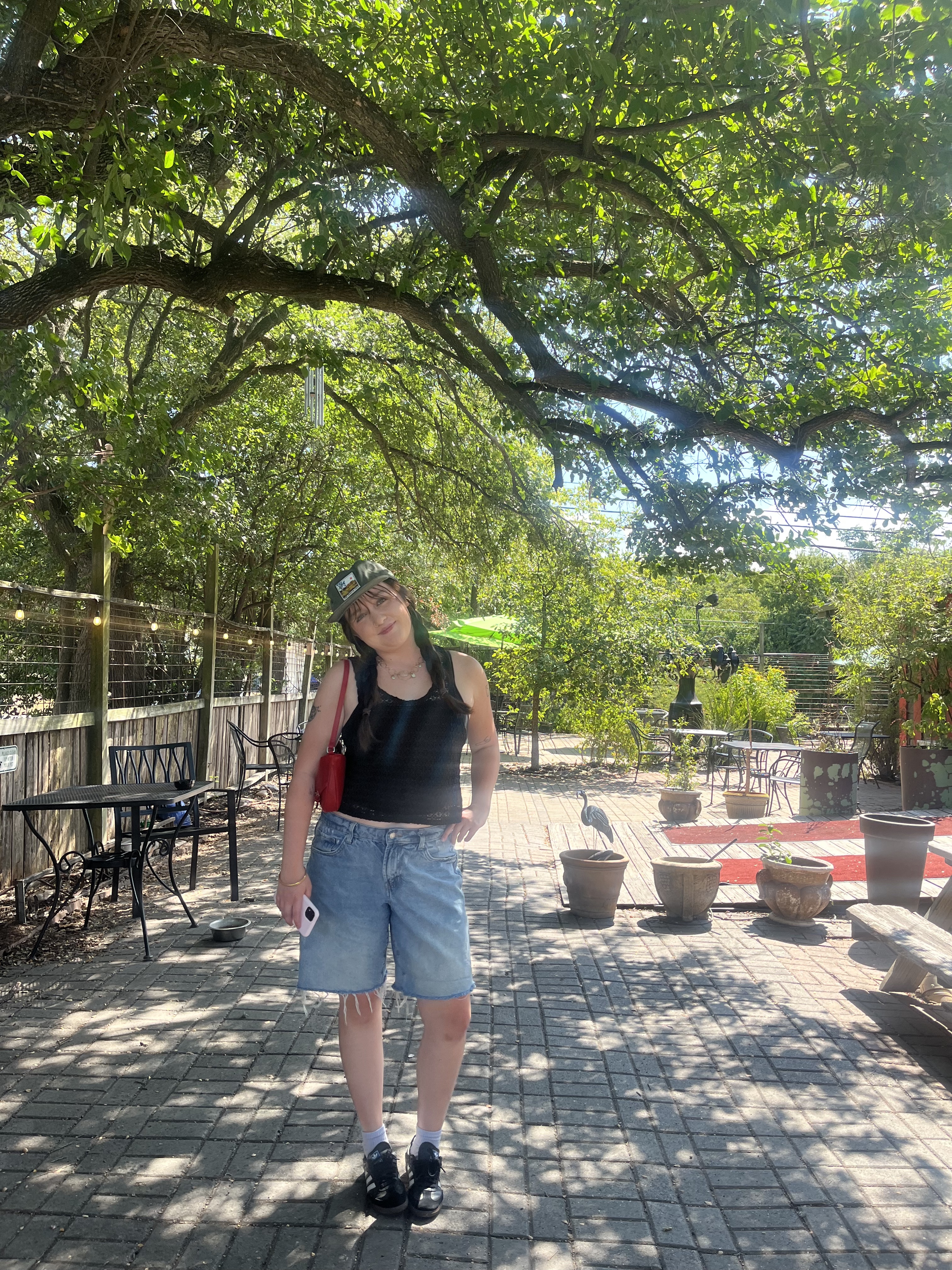 Taylor standing outside on the patio at Wake the Dead Coffee House
